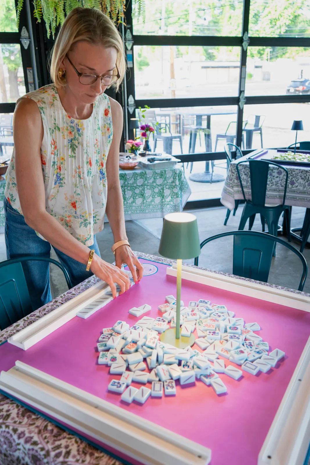 Allison Merriman setting up an American mahjong table at Vaulted Oak Brewing in Charlotte